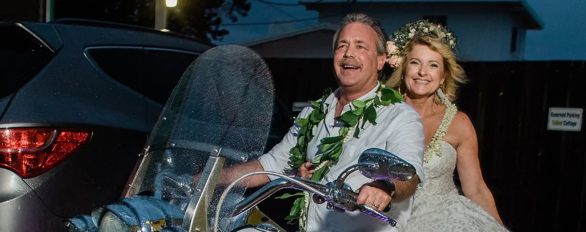 Pastor Mark and Kelli Turansky on a motorcycle, Kelli in a wedding dress